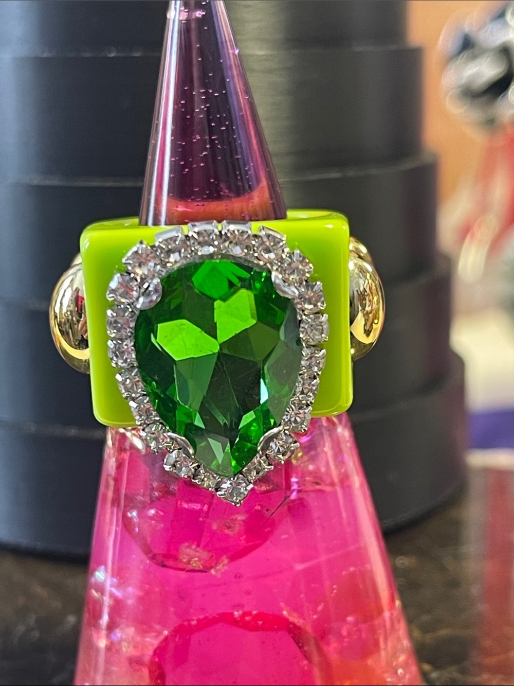 Green Acrylic Ring w/ teardrop-shaped emerald-color stone framed in rhinestones